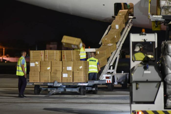 Workers at Havana airport unload medical equipment donated by China