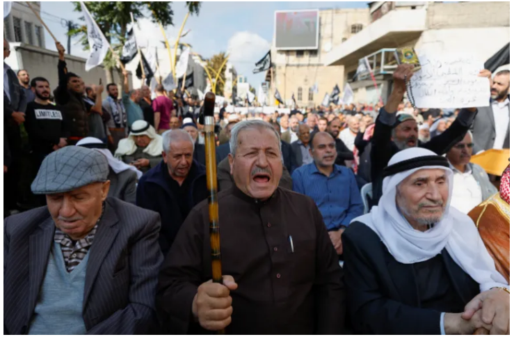 Palestinians in Hebron, West Bank, demonstrate in solidarity with Gaza, 15 October 2023 [Mussa Qawasma/Reuters]
